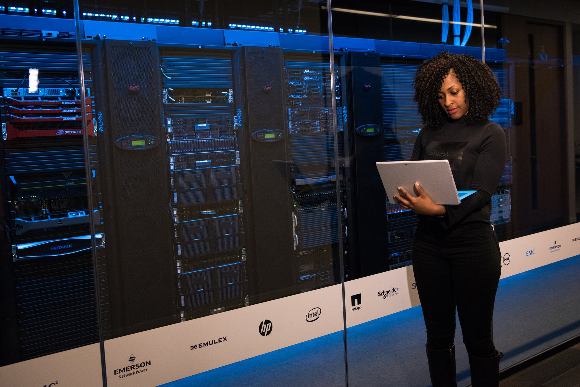 Home 3 software engineer standing beside server racks